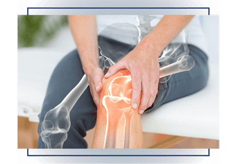 Person holding an aching knee